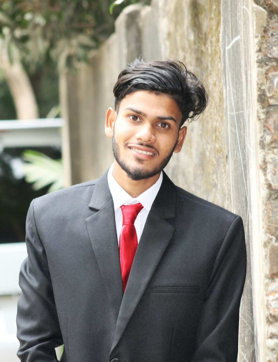 Portrait of a young man in a suit smiling confidently