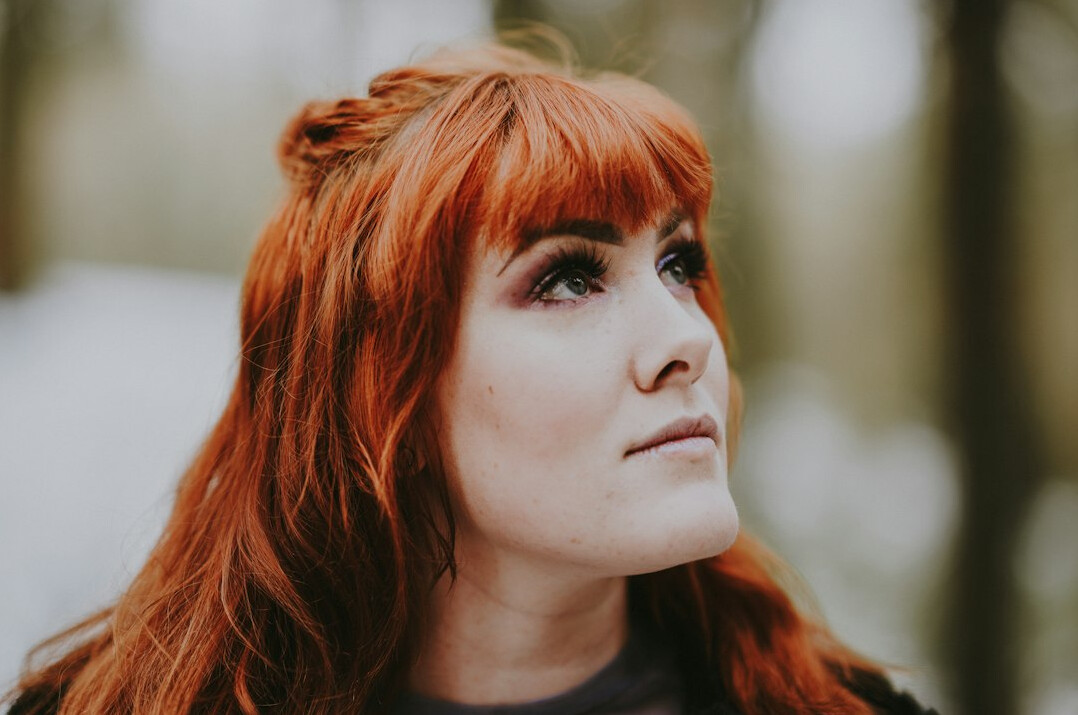 Portrait of a young woman with red hair looking thoughtfully